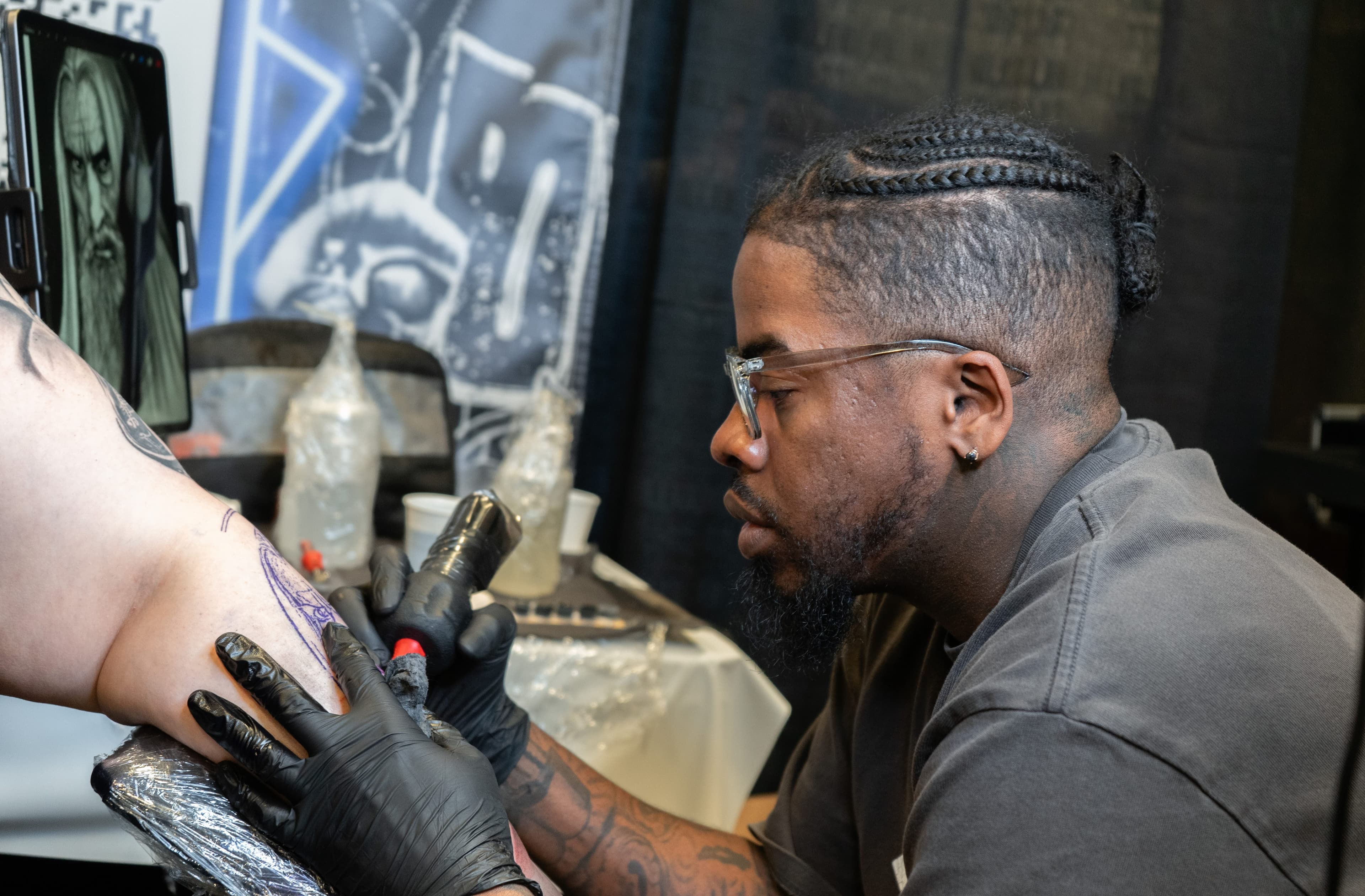 Tattoo artist at work on TattMe, scene 1