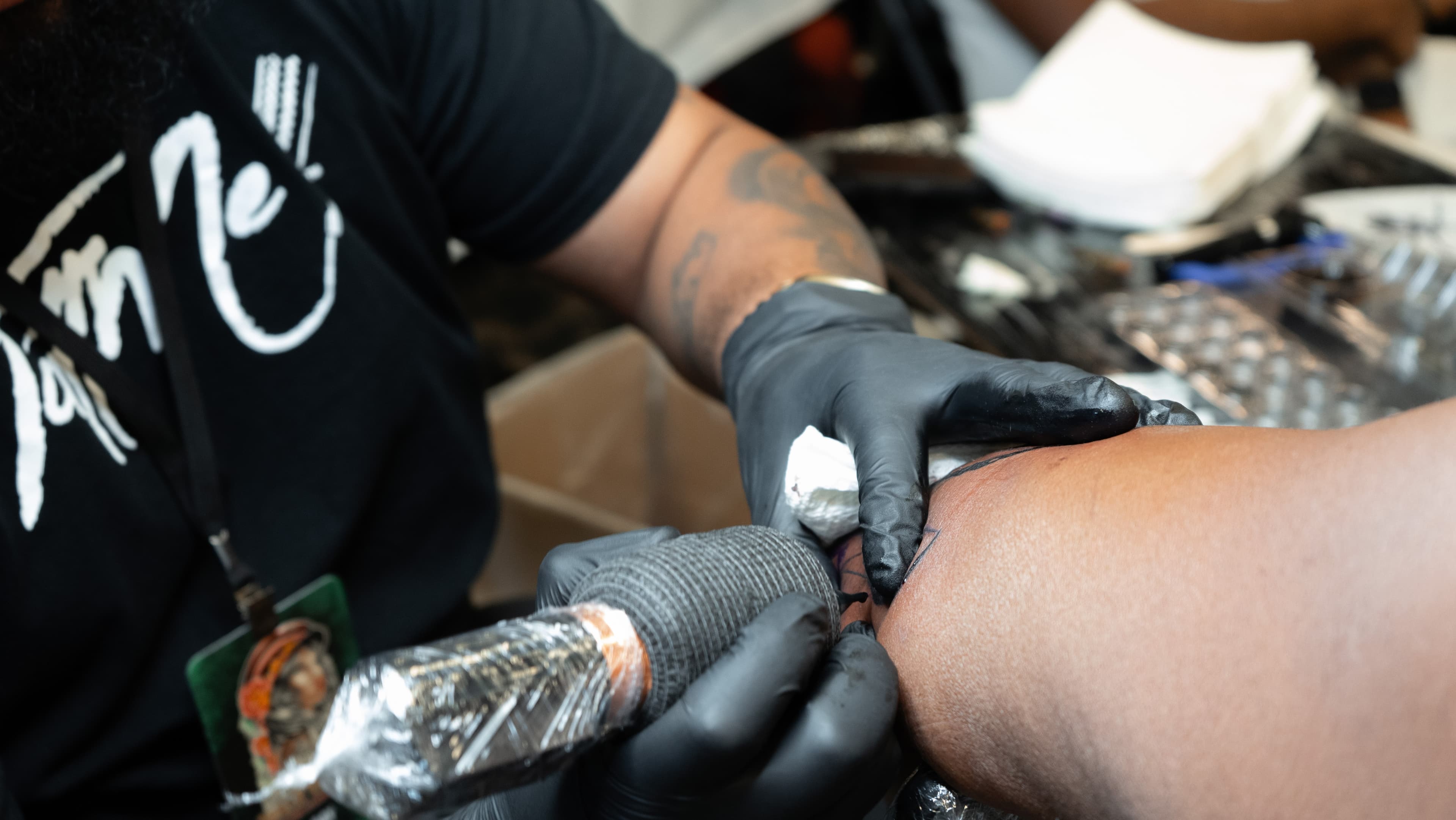 Tattoo artist at work on TattMe, scene 3