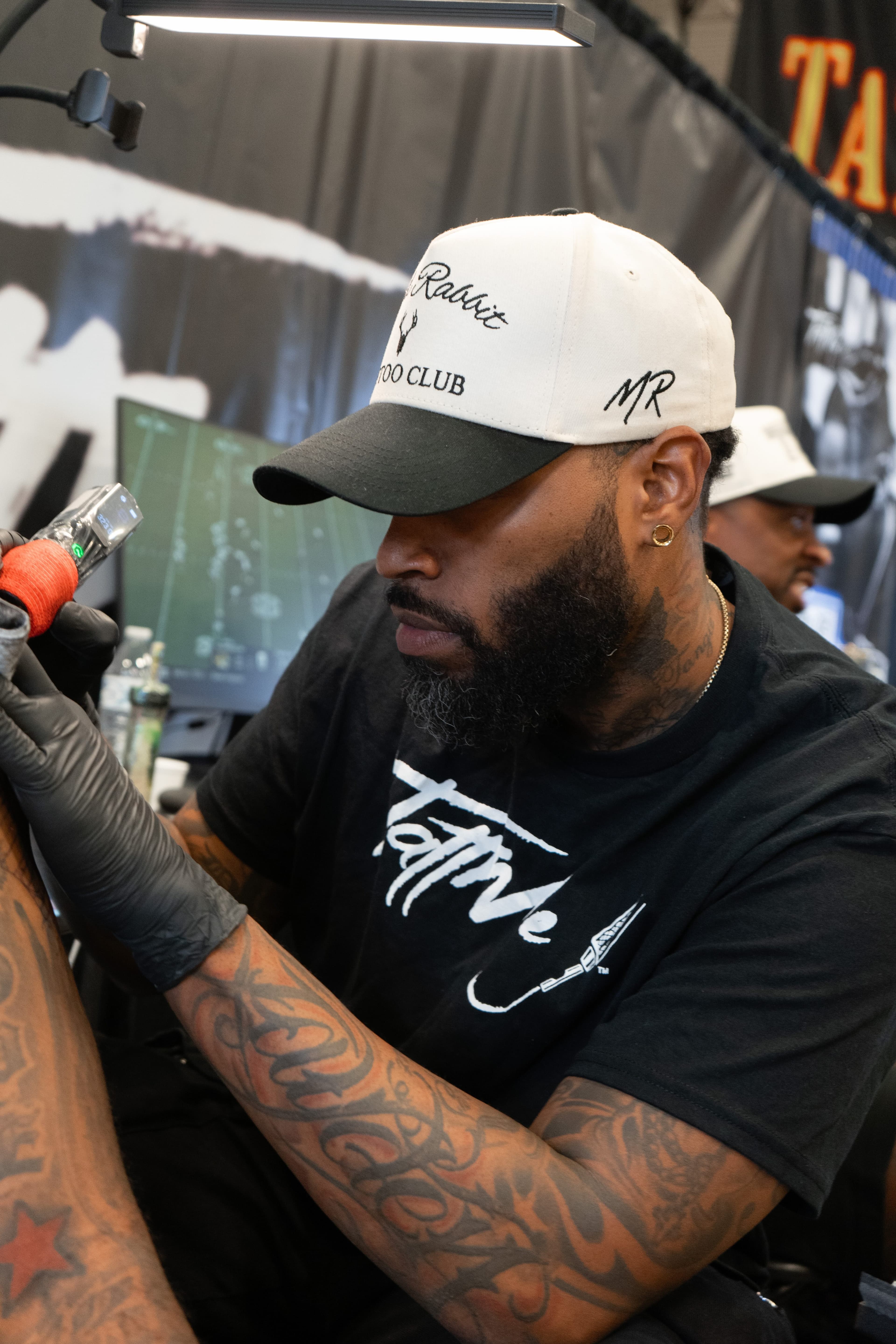 TattMe artist working with a client during a tattoo session