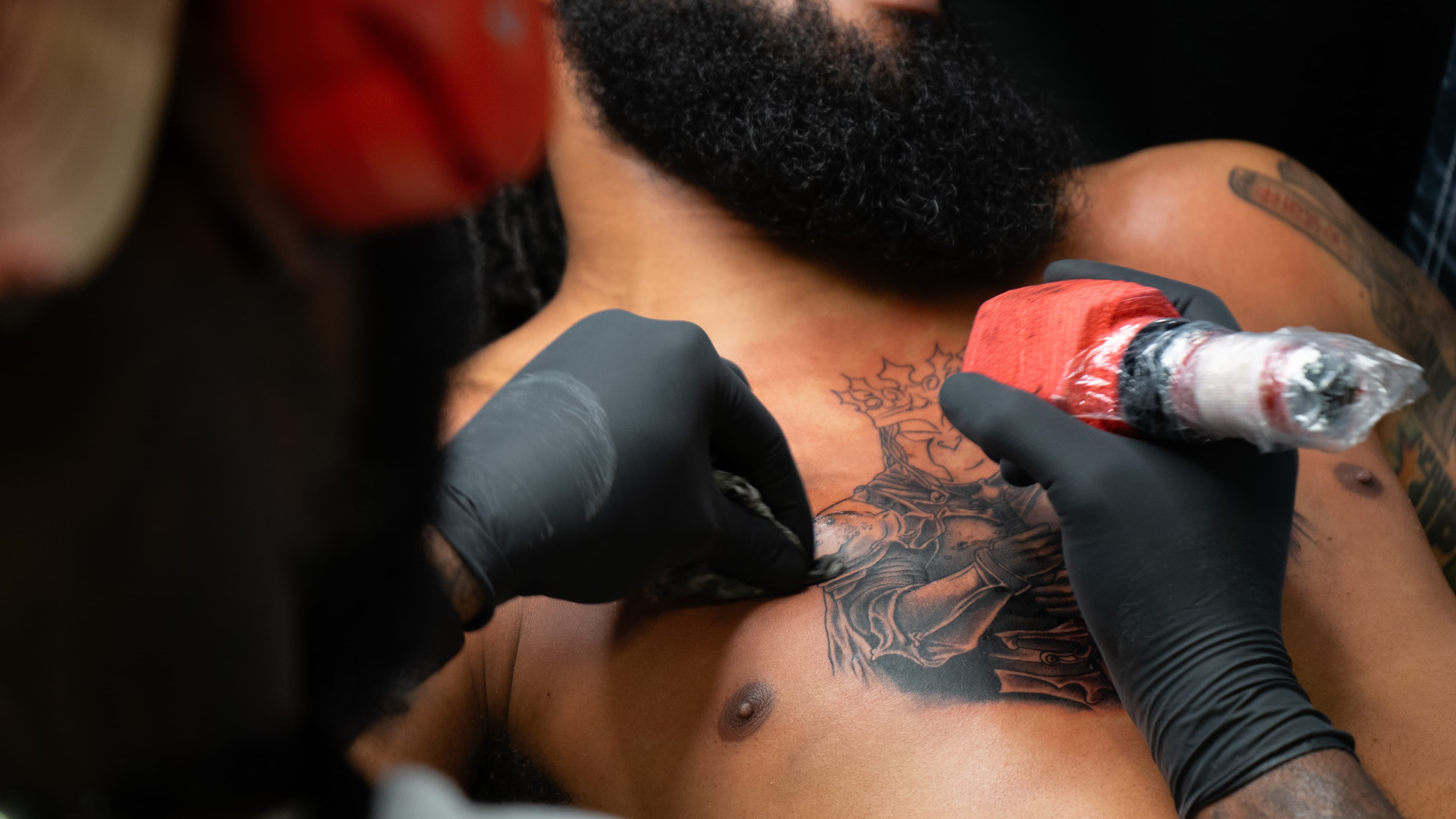 Tattoo artist at work on TattMe, scene 4