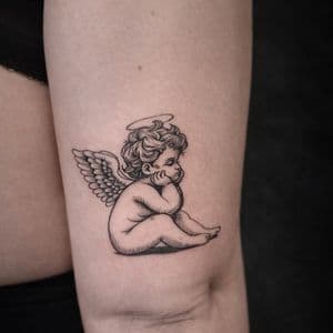 Black & Grey + Illustrative cherub tattoo on Thigh by The_Alley_Tattoo_Studio on TattMe