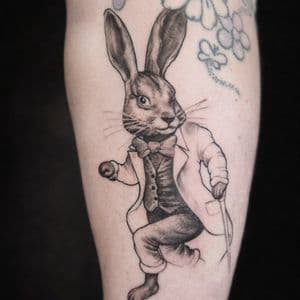 Black & Grey + Illustrative rabbit tattoo on Upper Arm by The_Alley_Tattoo_Studio on TattMe
