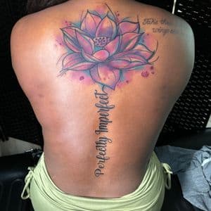 Watercolor + Lettering lotus tattoo on Spine by Inkflowjo on TattMe