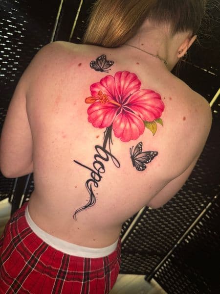 Floral + Lettering hibiscus tattoo on Upper Back by Inkflowjo on TattMe