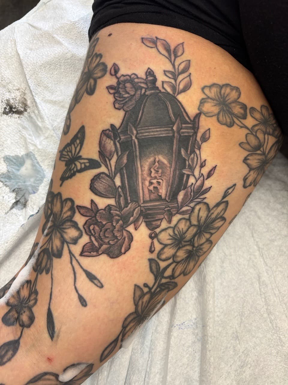 Black & Grey + Floral lantern tattoo on Thigh by tattoo_panda on TattMe