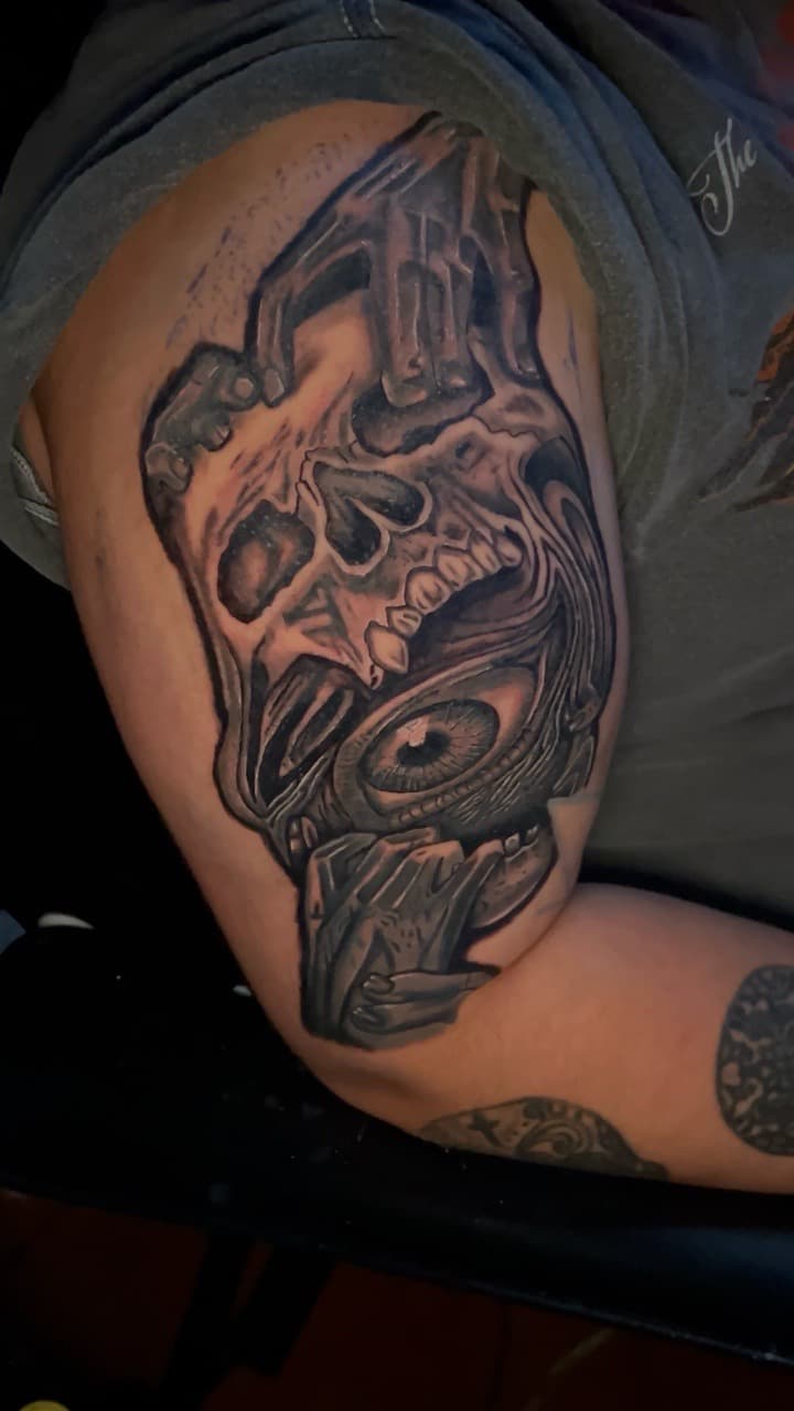 Black & Grey + Surrealism skull tattoo on Upper Arm by KC on TattMe