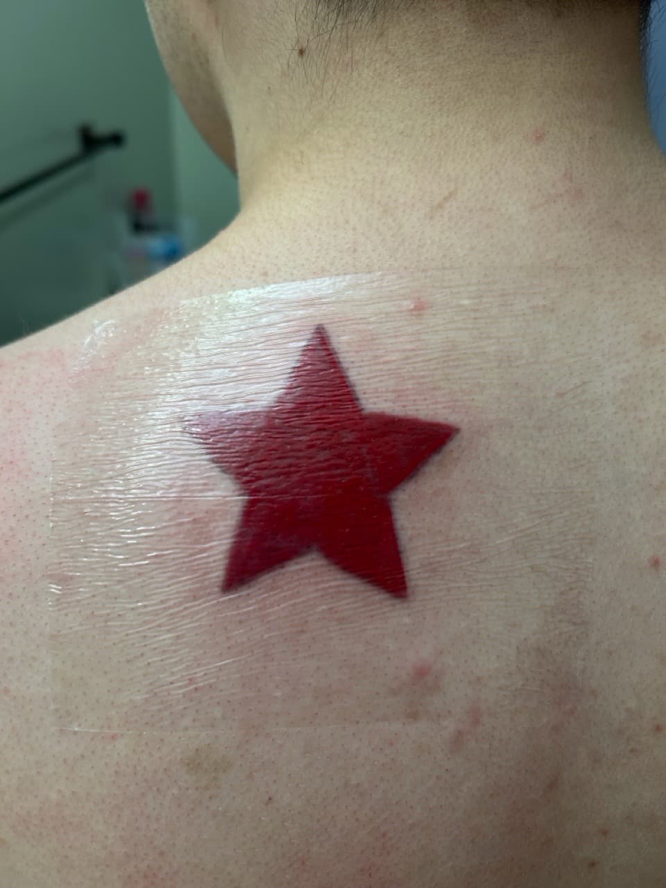 Minimalist + Color red tattoo on Upper Back by Apex_Effort_Studio on TattMe