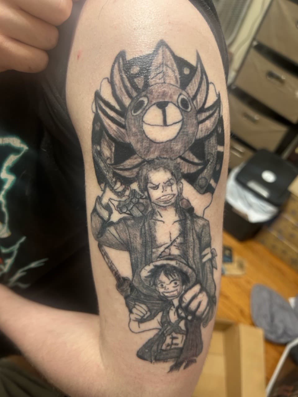 Anime + Black & Grey characters tattoo on Upper Arm by Apex_Effort_Studio on TattMe