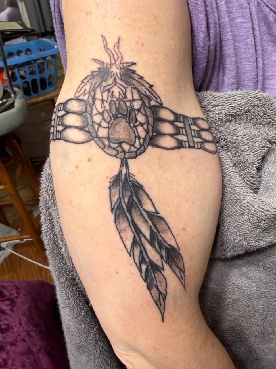 Black & Grey + Illustrative paw print tattoo on Upper Arm by Apex_Effort_Studio on TattMe