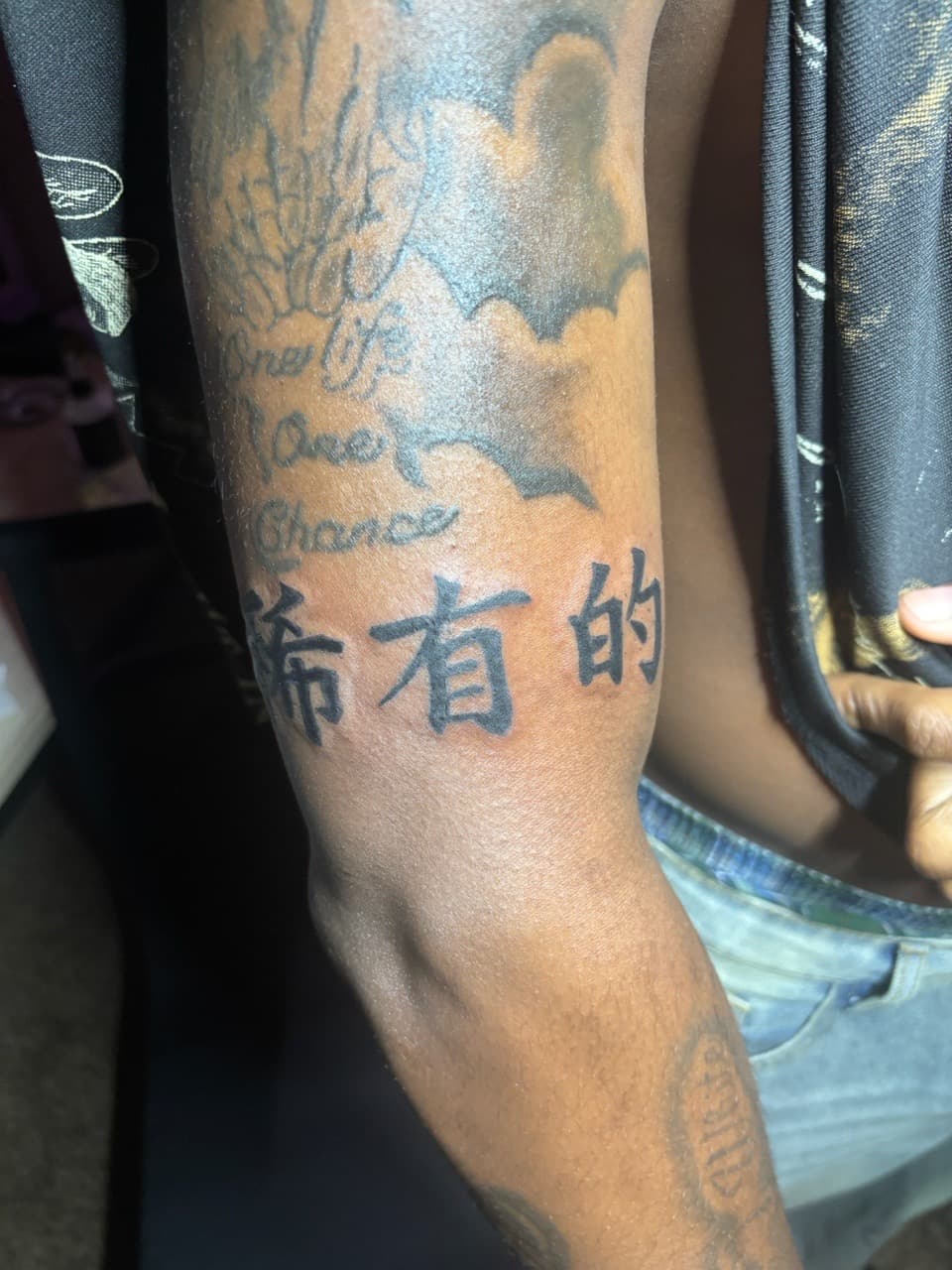 Lettering + Black-work characters tattoo on Upper Arm by tatsbyrayyy on TattMe