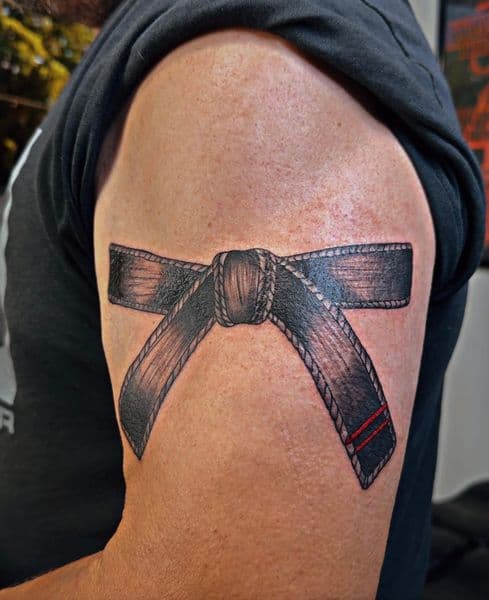 Black & Grey + Realism black belt tattoo on Upper Arm by Wasted_Ink on TattMe