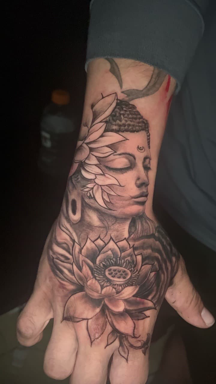 Black & Grey + Floral buddha tattoo on Hand by Rey_Sanchez on TattMe