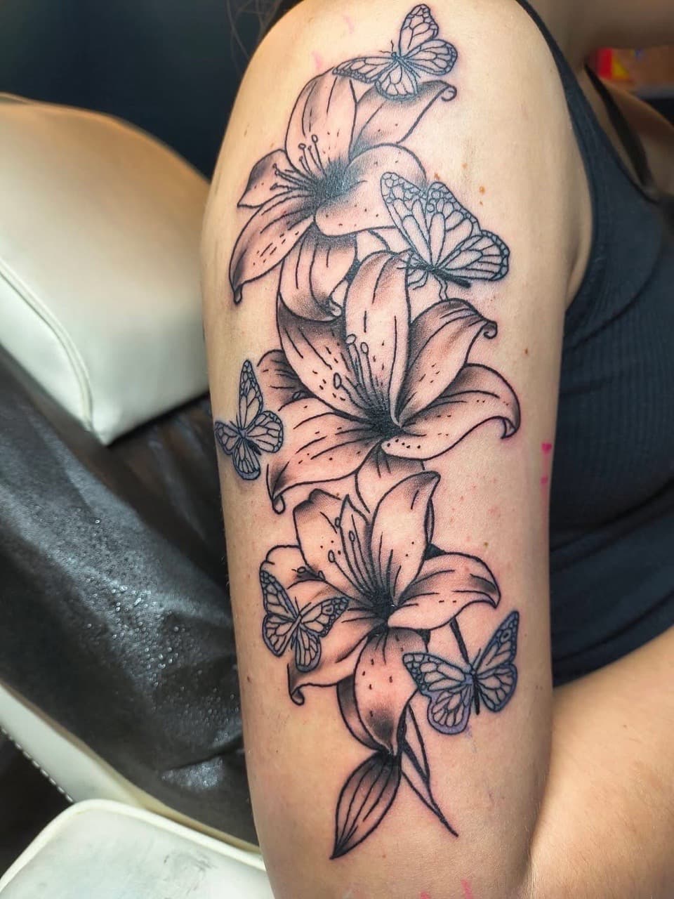 Fine Line + Floral lilies tattoo on Upper Arm by Night_Veil_Ink on TattMe