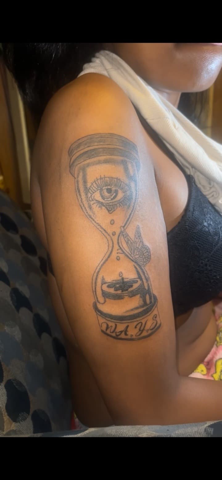 Black & Grey + Illustrative hourglass tattoo on Upper Arm by JrrrInkkk on TattMe