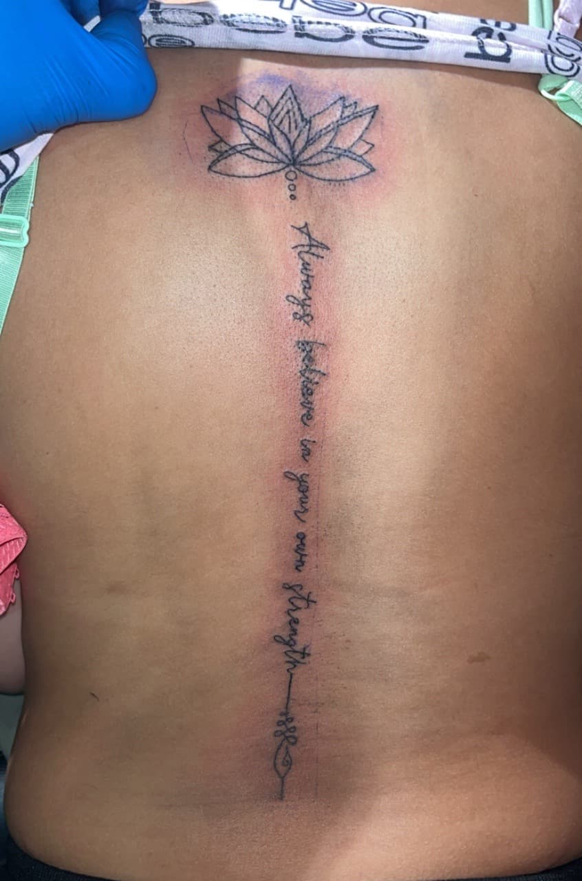 Fine Line + Script lotus tattoo on Spine by JrrrInkkk on TattMe