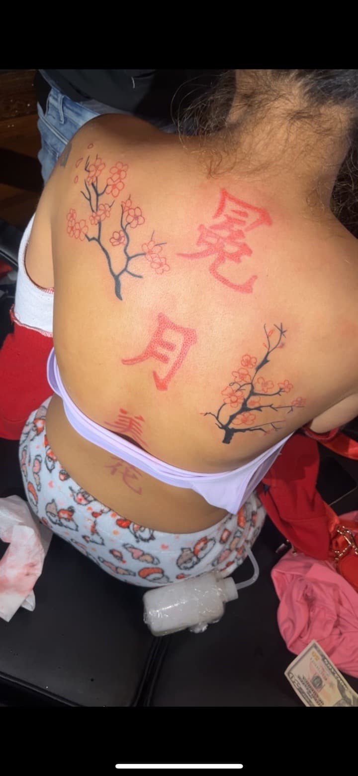 Lettering + Floral japanese characters tattoo on Upper Back by JrrrInkkk on TattMe
