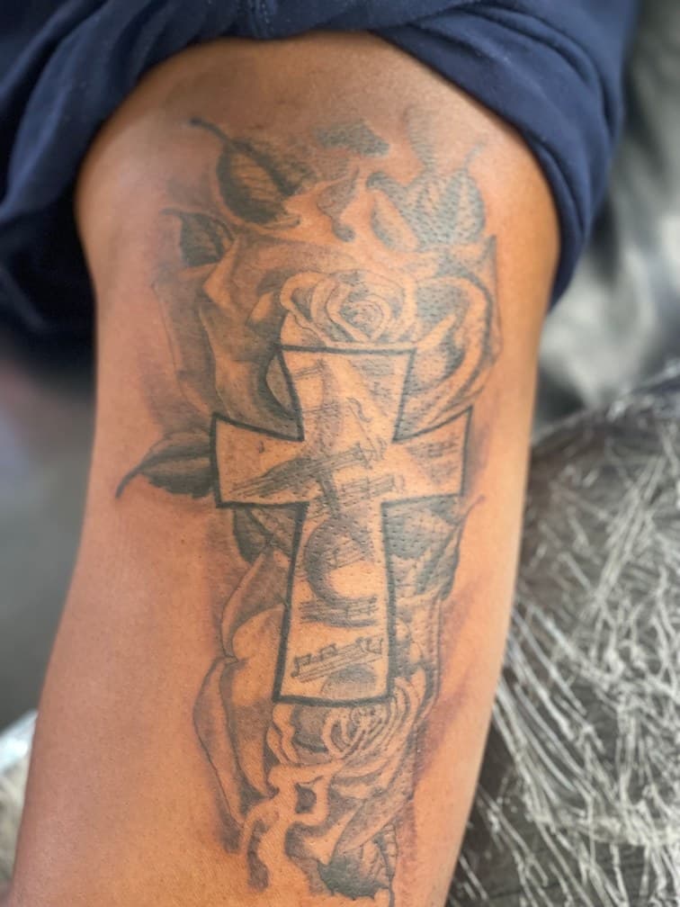 Black & Grey + Floral cross tattoo on Upper Arm by Jamarious_Cook on TattMe