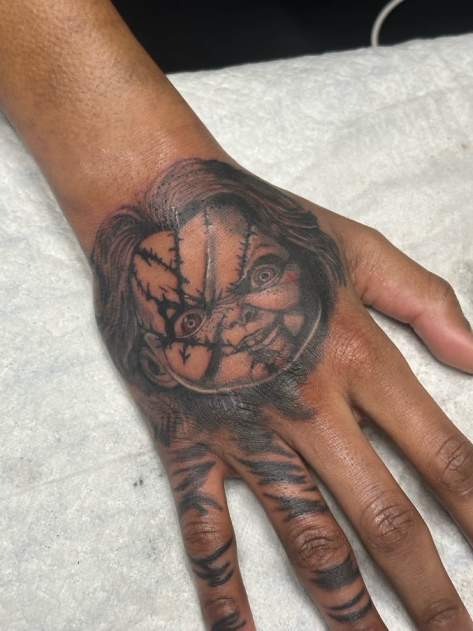 Black & Grey + Horror chucky tattoo on Hand by Jamarious_Cook on TattMe