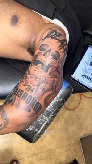 Black & Grey + Lettering skull tattoo on Upper Arm by Jamarious_Cook on TattMe