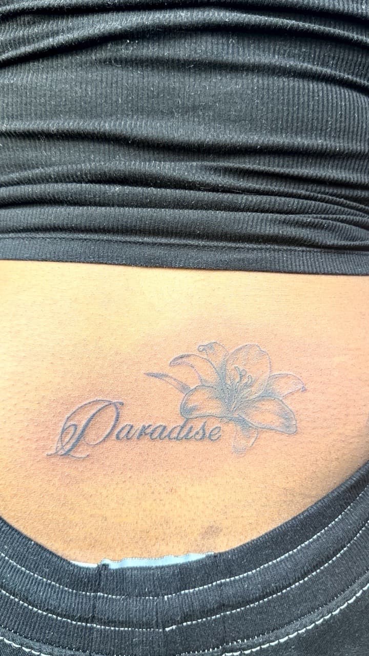 Script + Floral paradise tattoo on Lower Back by Speedytattoos on TattMe