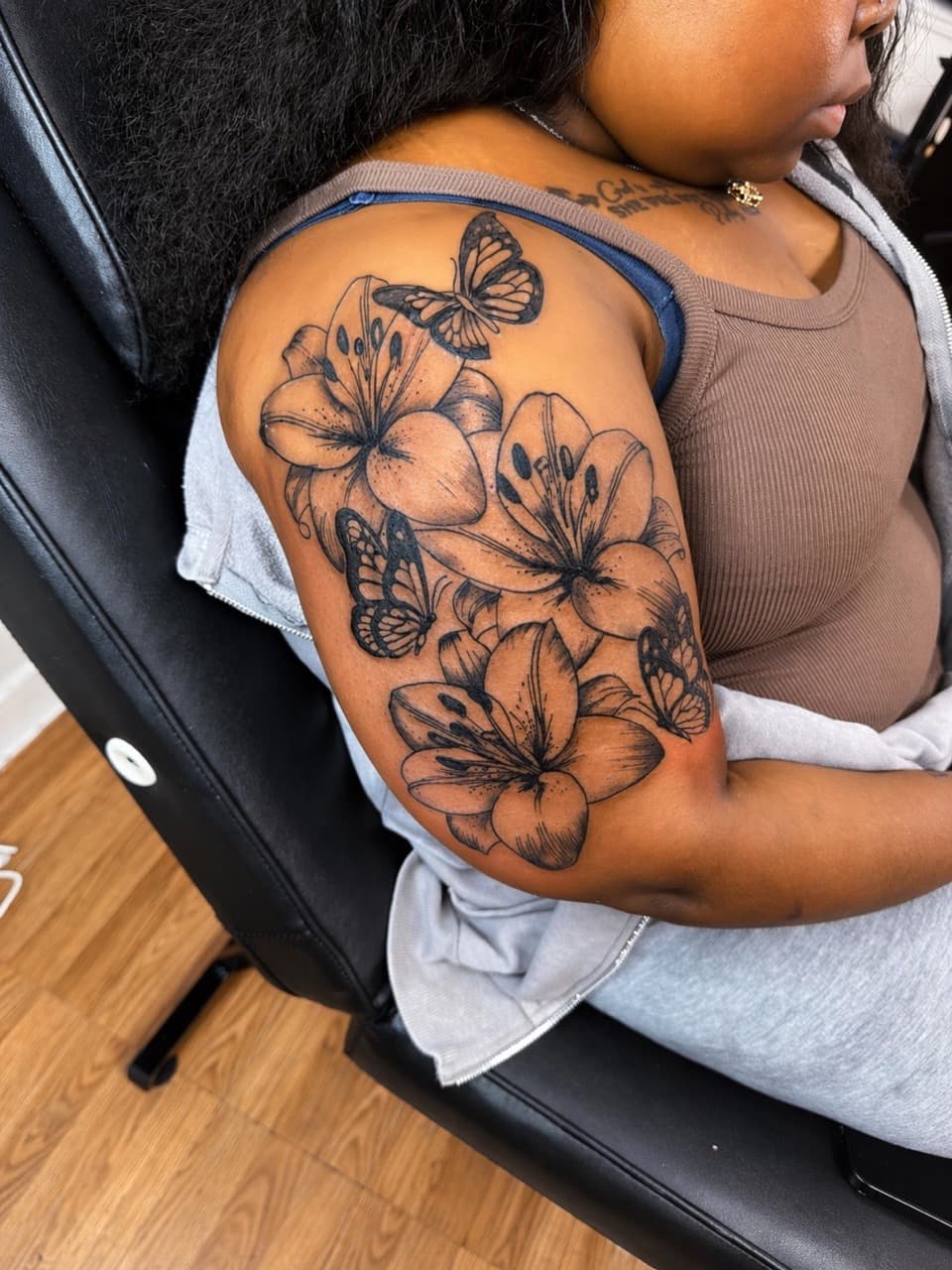 Fine Line + Black & Grey lilies tattoo on Upper Arm by Speedytattoos on TattMe