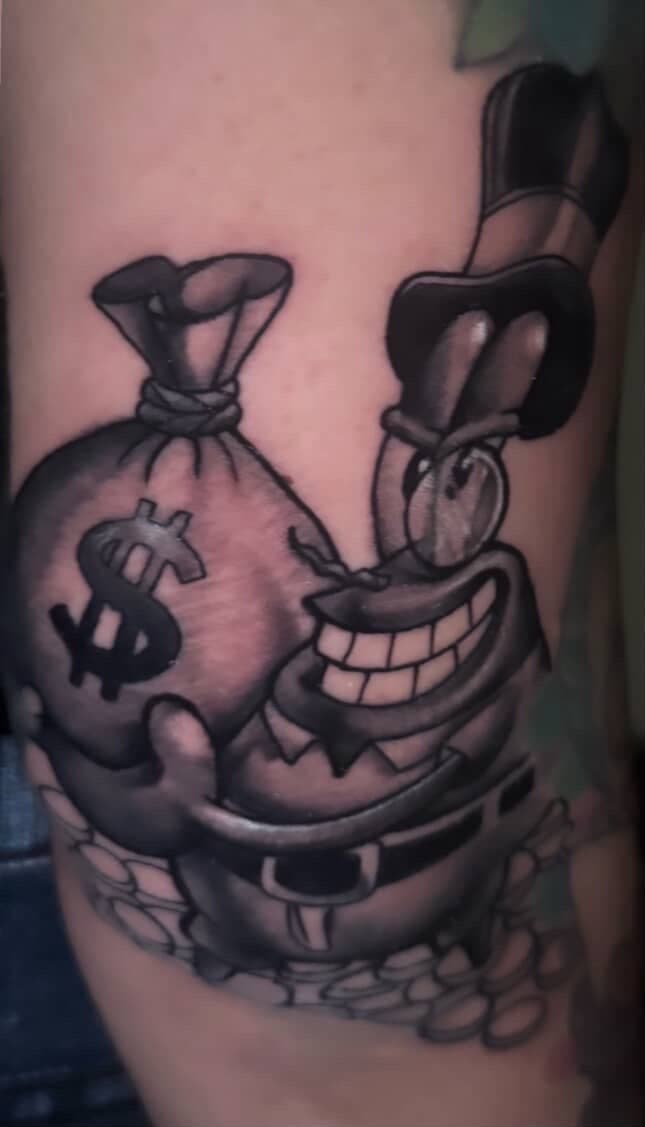 Black & Grey + Cartoon money bag tattoo on Upper Arm by LEGENDARY_HANDZ on TattMe