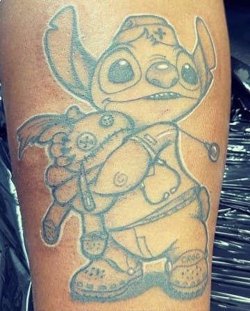Pop Culture + Cartoon stitch tattoo on Upper Arm by Chris on TattMe