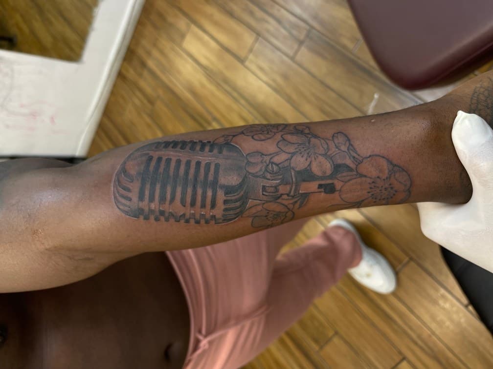 Black & Grey + Illustrative microphone tattoo on Forearm by Chris on TattMe