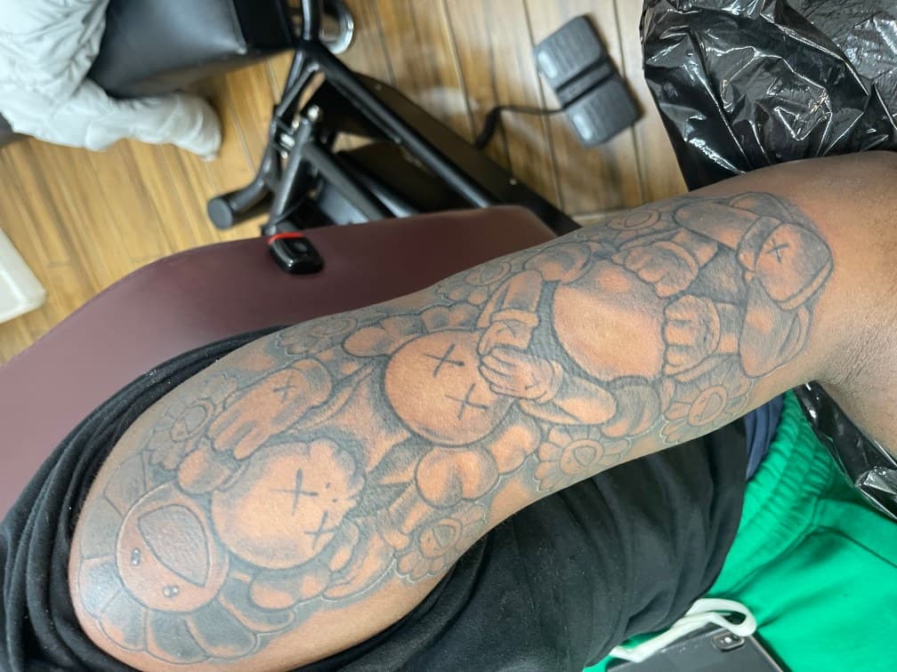 Pop Culture + Cartoon kaws tattoo on Half Sleeve by Chris on TattMe