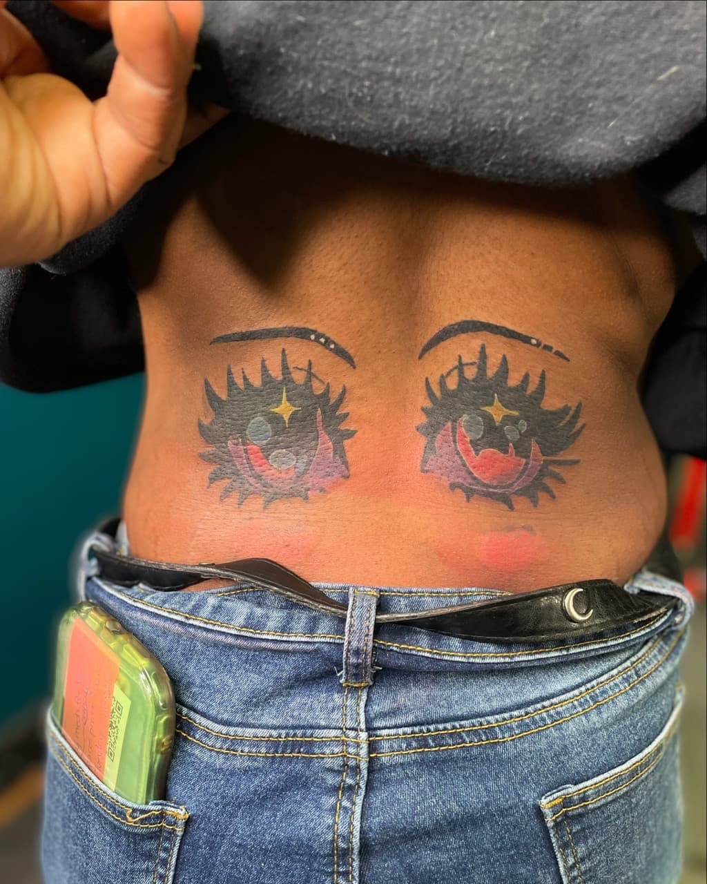 Anime + Cartoon eyes tattoo on Lower Back by Ariesinkedme on TattMe