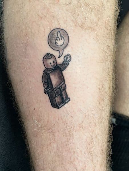Illustrative + Black & Grey lego minifigure tattoo on Forearm by Ariesinkedme on TattMe