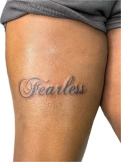 Lettering + Script fearless tattoo on Thigh by Ariesinkedme on TattMe