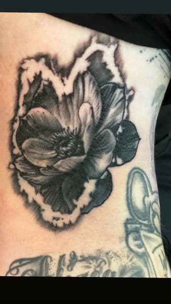 Black & Grey + Floral flower tattoo on Upper Arm by Profit on TattMe