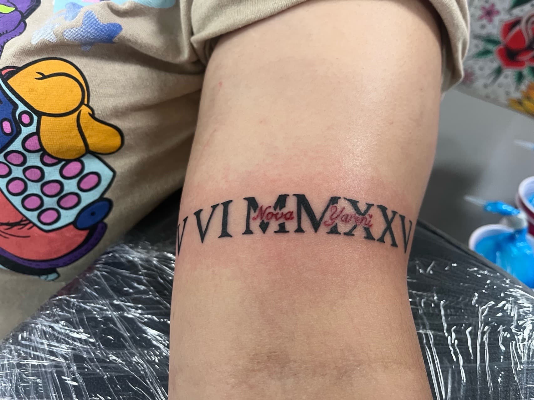 Lettering + Script roman numerals tattoo on Upper Arm by prodaJ on TattMe