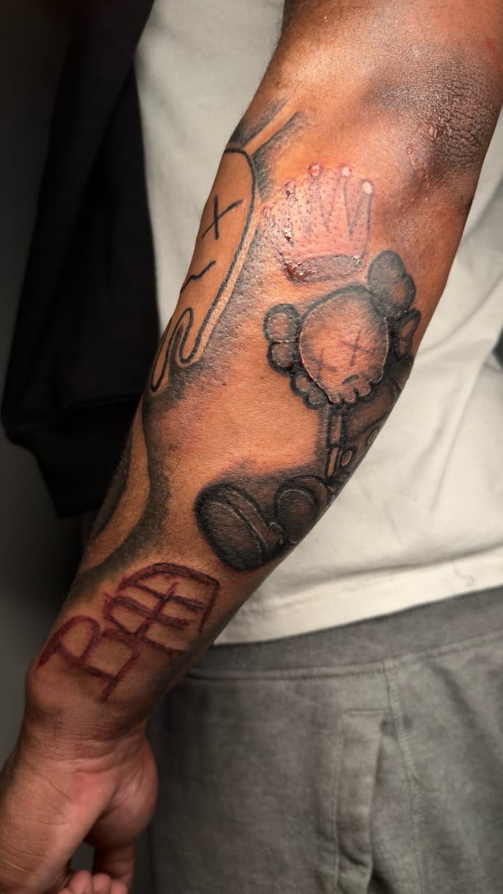 Black & Grey + Illustrative kaws tattoo on Upper Arm by yeahdatscjink on TattMe
