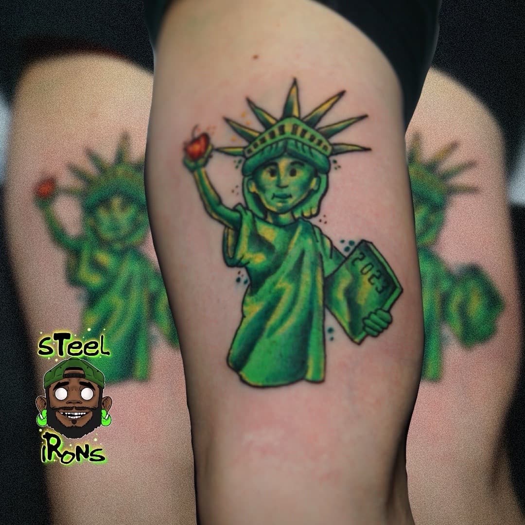 Cartoon + Color statue of liberty tattoo on Upper Arm by Steelirons on TattMe