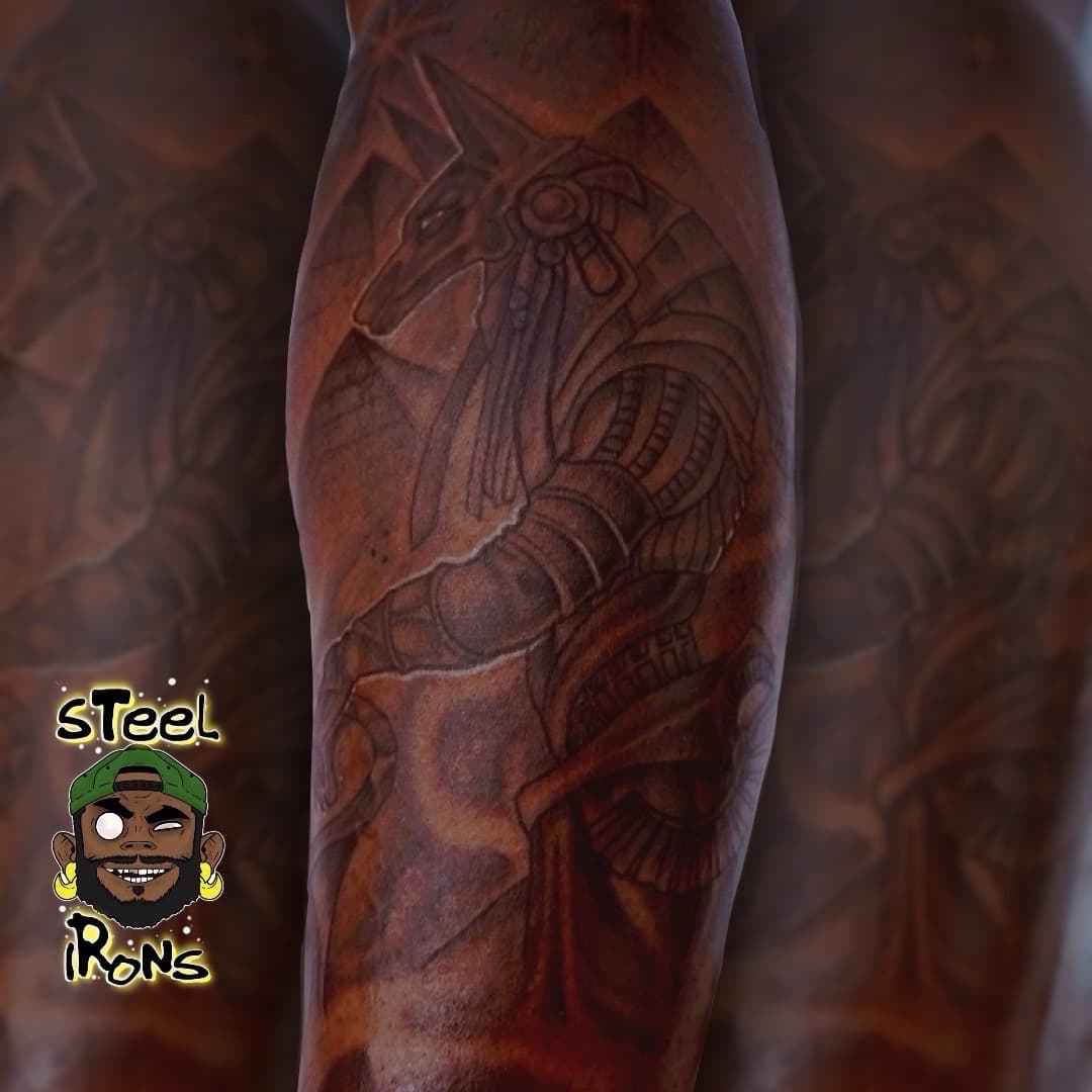 Black & Grey + Illustrative anubis tattoo on Upper Arm by Steelirons on TattMe