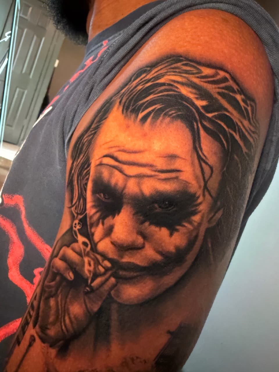 Realism + Black & Grey joker tattoo on Upper Arm by Noticeink on TattMe