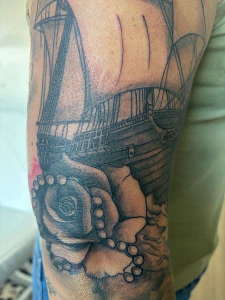 Black & Grey + Illustrative sailing ship tattoo on Upper Arm by Skull_Brothers_Ink on TattMe