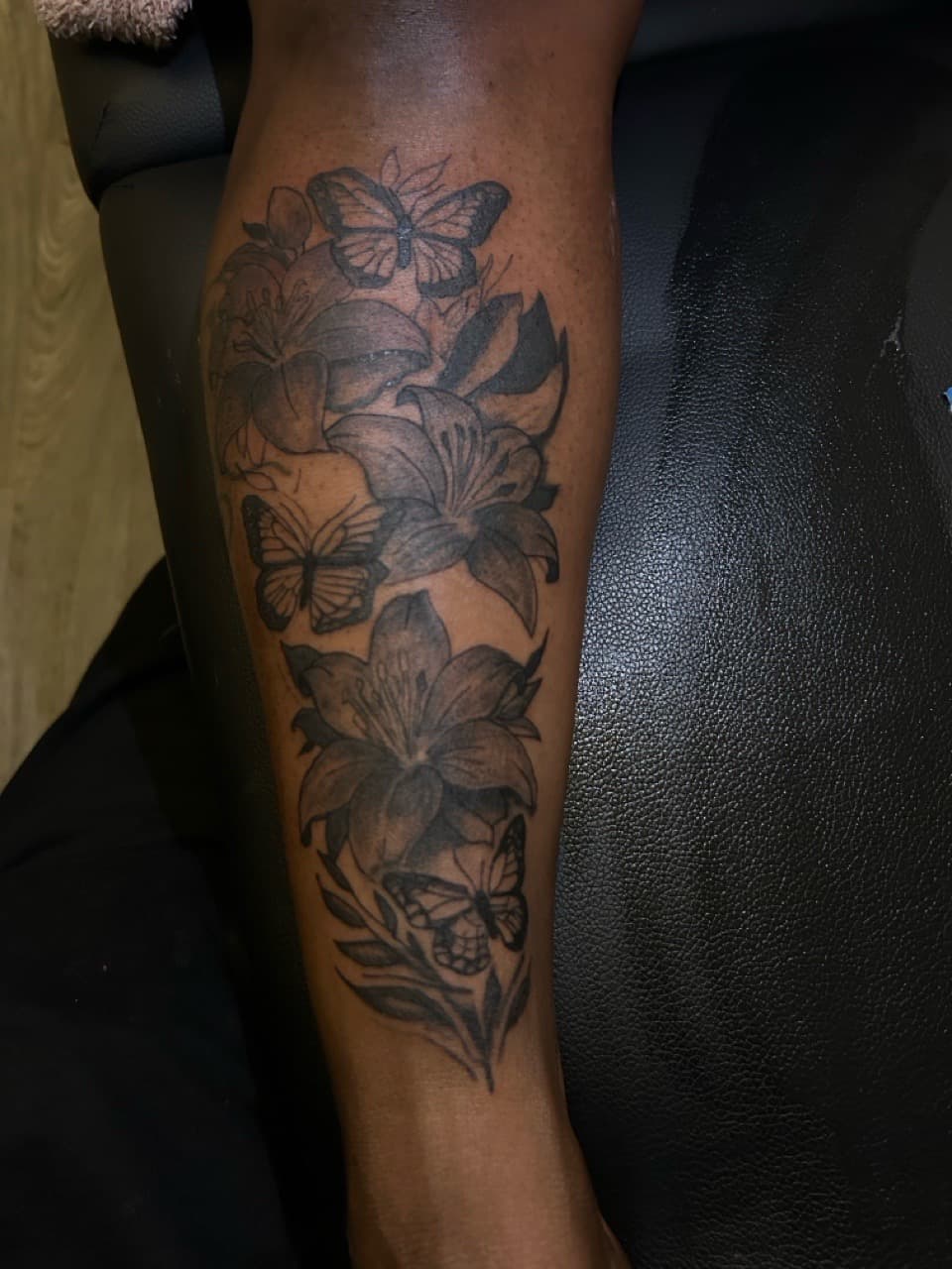 Black & Grey + Floral lilies tattoo on Calf by SnapInk on TattMe