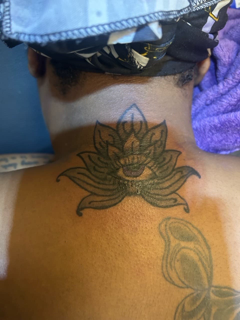 Line-work + Black-work lotus tattoo on Neck (Back) by SnapInk on TattMe