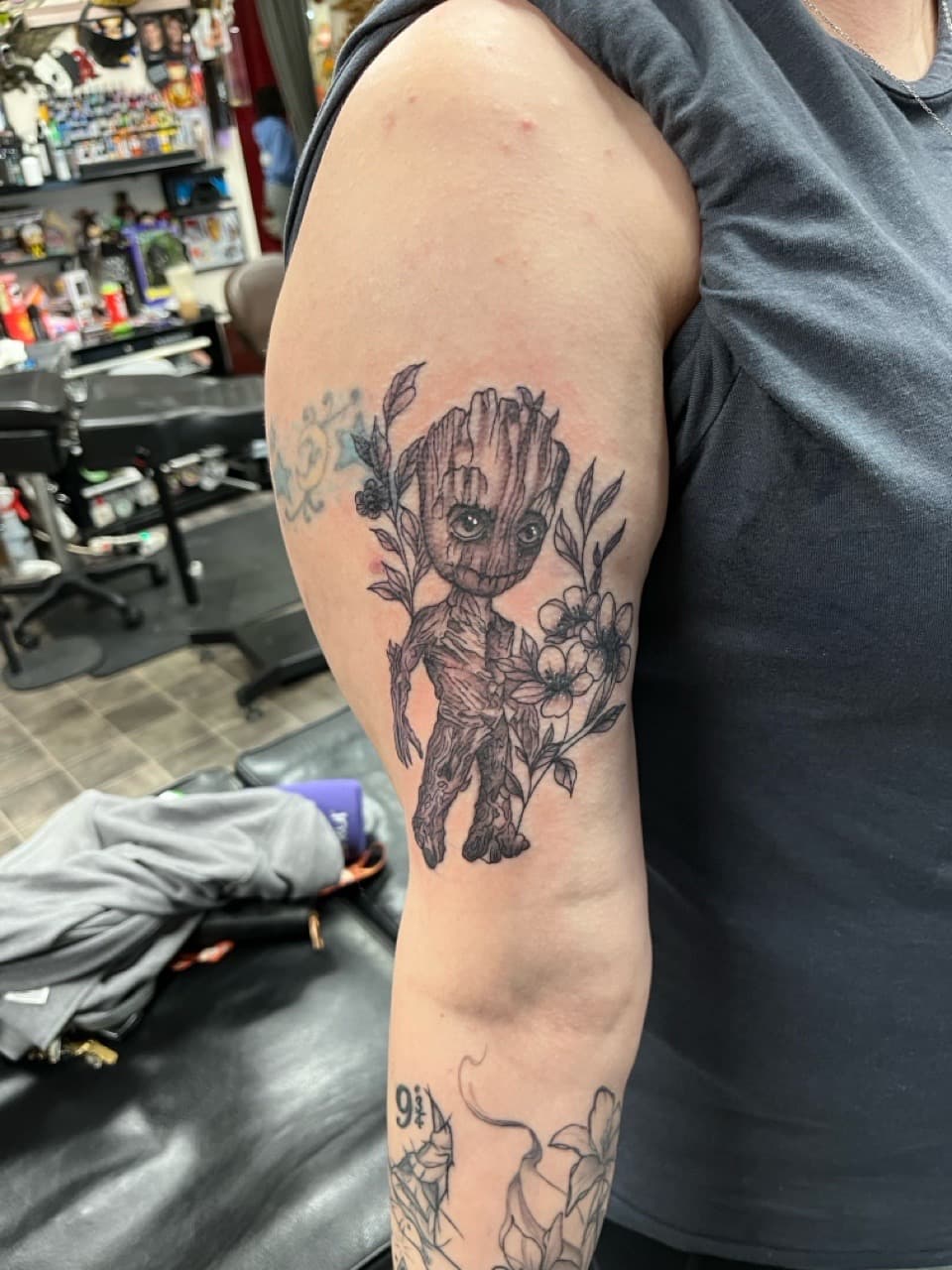 Illustrative + Black & Grey baby groot tattoo on Upper Arm by Kneedeep_tattoos on TattMe