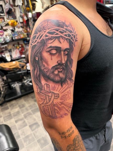 Black & Grey + Illustrative jesus tattoo on Upper Arm by Kneedeep_tattoos on TattMe