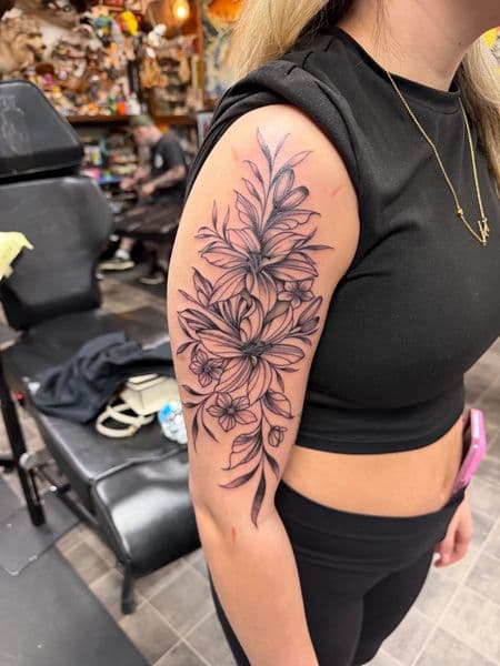 Floral + Line-work flowers tattoo on Upper Arm by Kneedeep_tattoos on TattMe