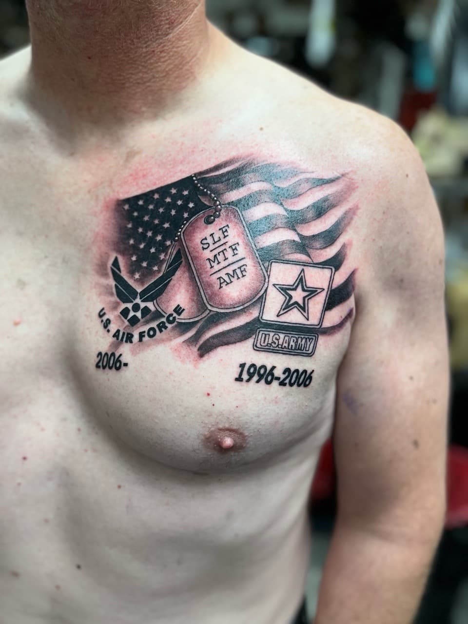 Black & Grey + Illustrative flag tattoo on Chest by Kneedeep_tattoos on TattMe