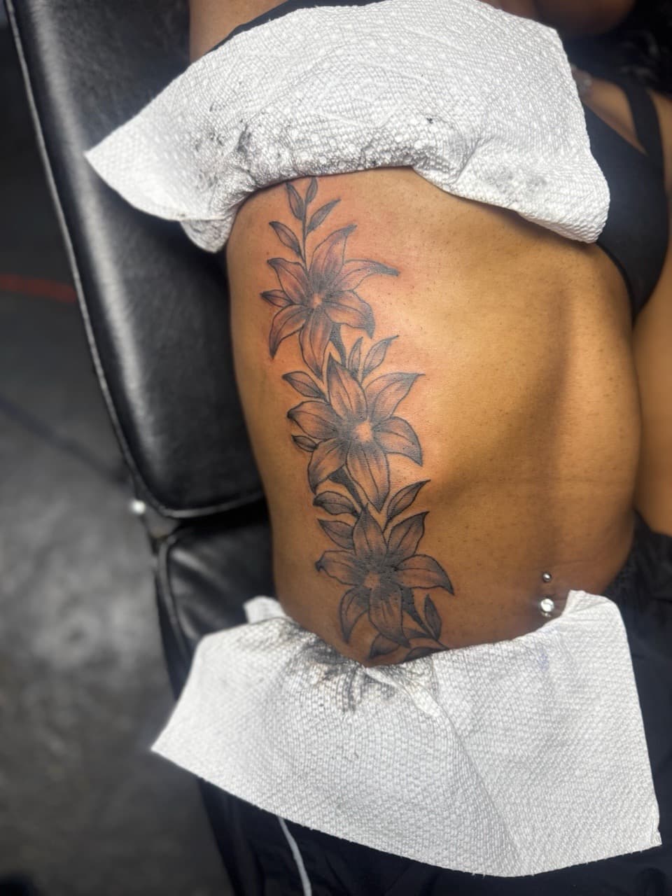 Floral + Black & Grey flowers tattoo on Ribs by HoodInkedd843 on TattMe