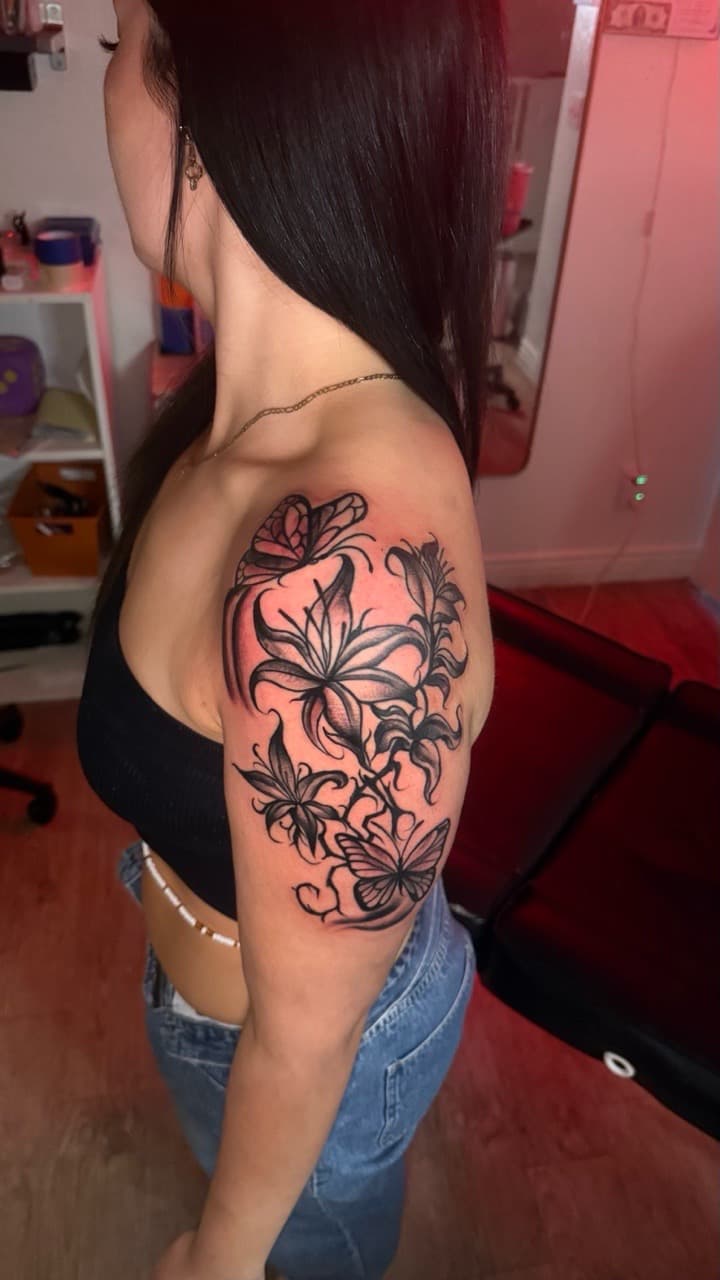Black & Grey + Floral lilies tattoo on Upper Arm by Tatted_By_Visions on TattMe