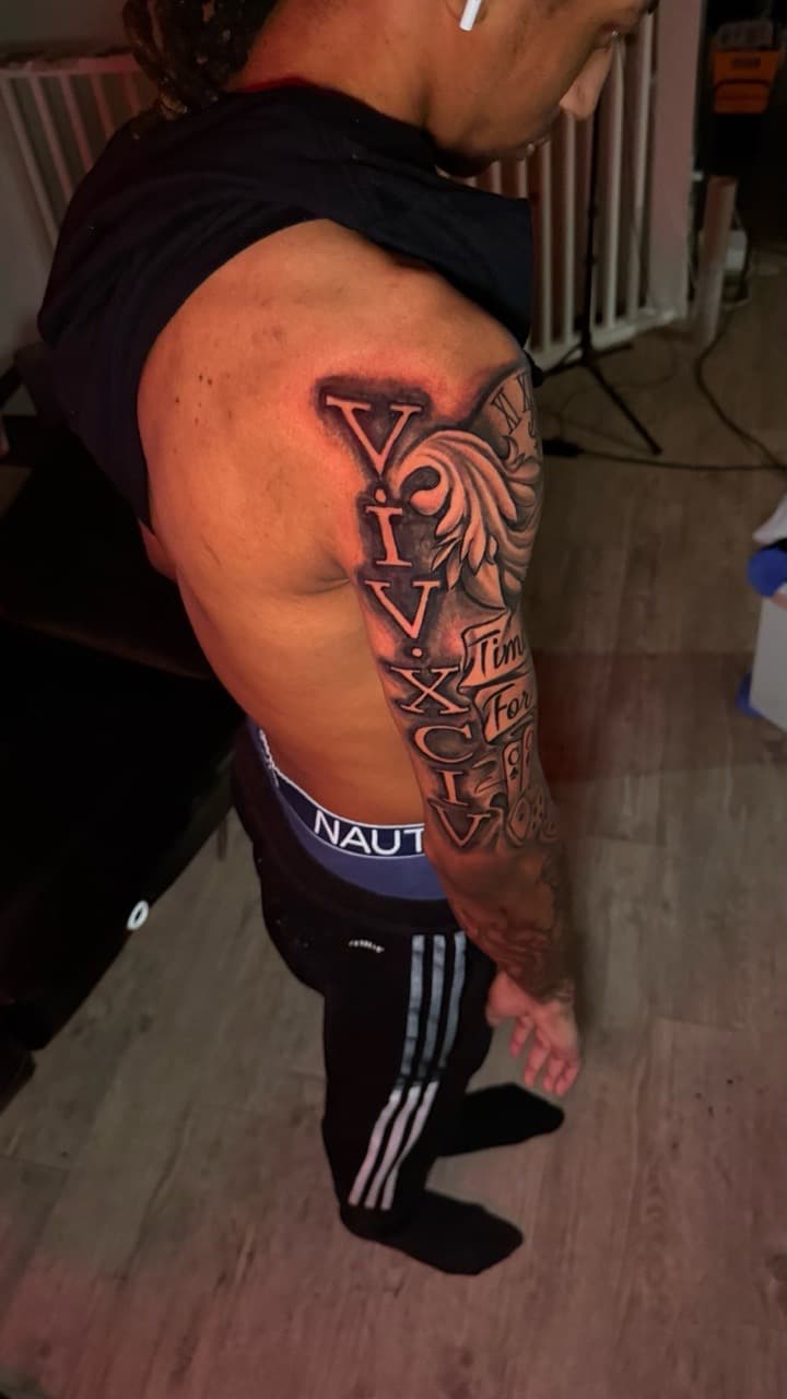 Black & Grey + Lettering roman numerals tattoo on Full Sleeve by Tatted_By_Visions on TattMe