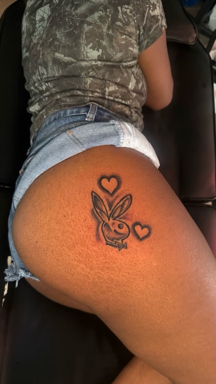 Black & Grey + Pop Culture playboy bunny tattoo on Thigh by Tatted_By_Visions on TattMe