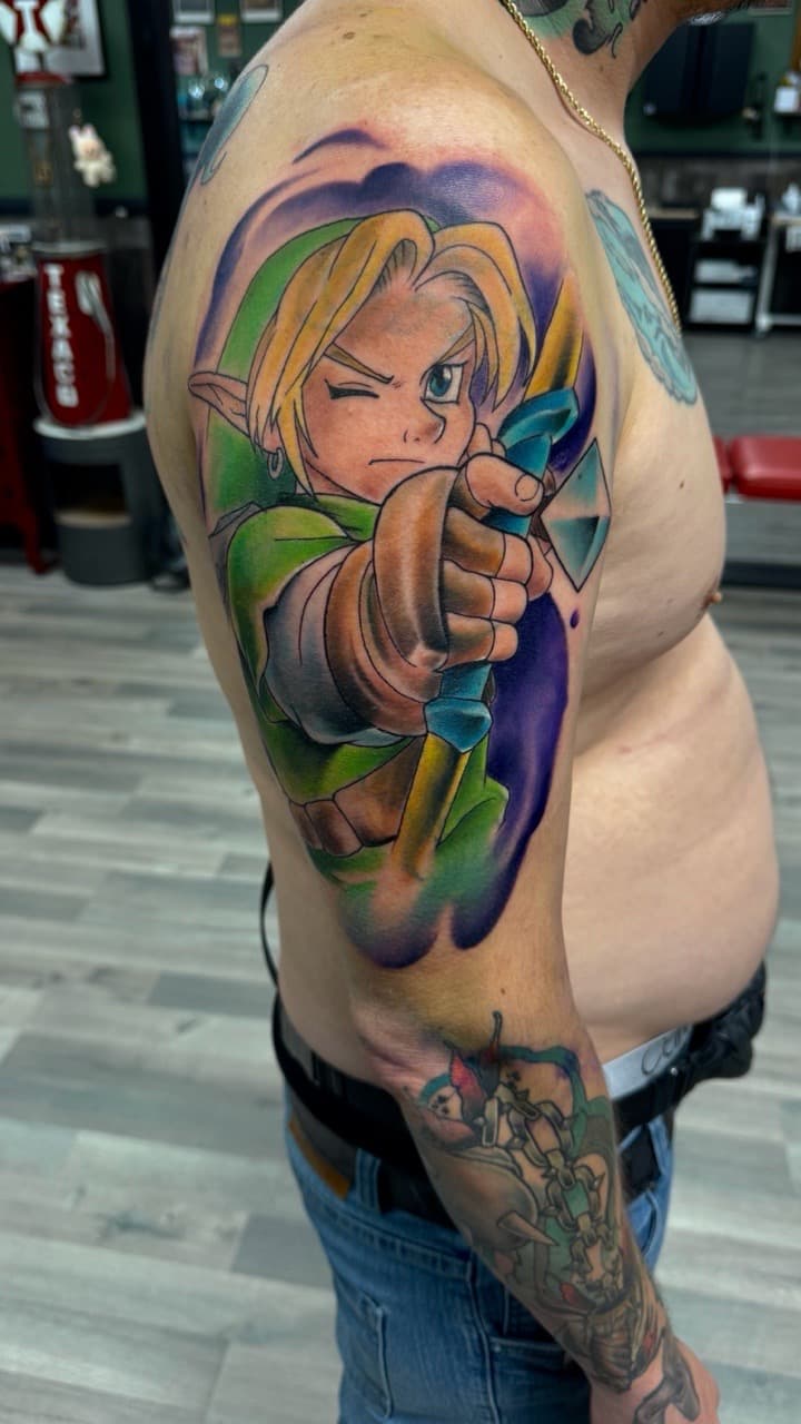 Anime + Pop Culture link tattoo on Upper Arm by Radtattoo on TattMe
